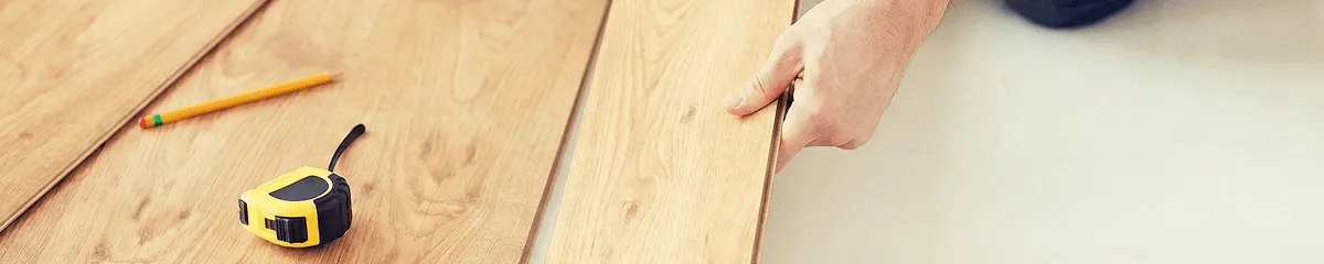 A professional installing wood flooring in Overland Park, KS