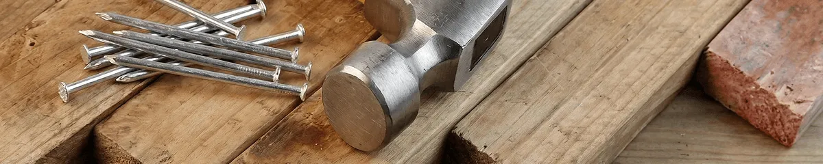 Hammer and nails on hardwood flooring boards in Overland Park, KS