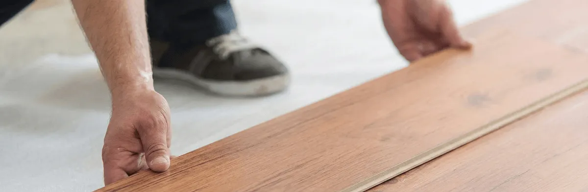 A professional installing laminate flooring in Overland Park, KS