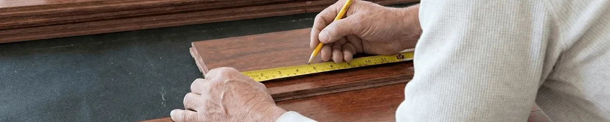 A professional installing wood flooring in Overland Park, KS